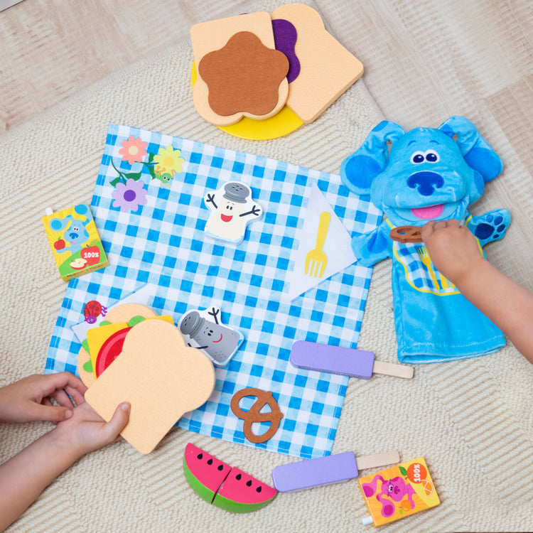 A playroom scene with The Melissa & Doug Blue’s Clues & You! Share with Blue Picnic Play Set with Hand Puppet