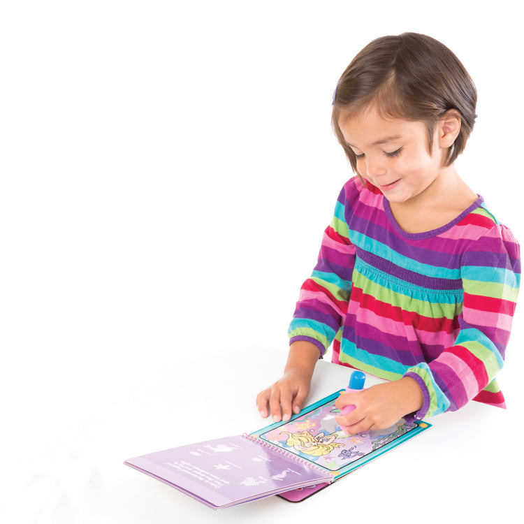 A child on white background with The Melissa & Doug On the Go Water Wow! Reusable Water-Reveal Activity Pad - Fairy Tale