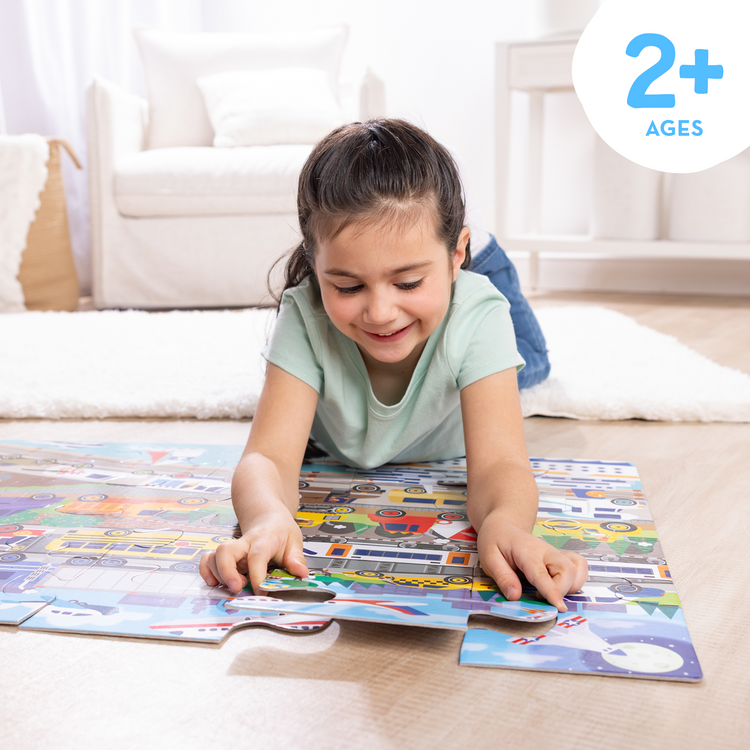 A kid playing with The Melissa & Doug Traffic Jam, City Vehicle Themed Jumbo Floor Puzzle, 24-Piece Jigsaw Puzzle with Multiple Vehicles, 3 x 2 Foot Toddler Puzzles for Kids Ages 3+