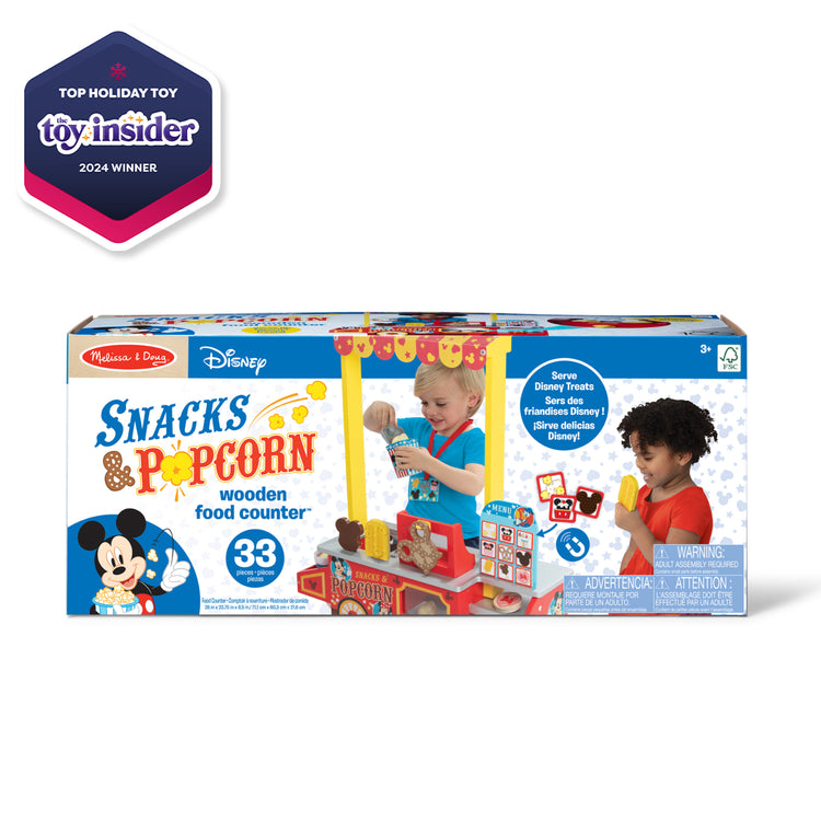 The front of the box for The Melissa & Doug Disney Snacks & Popcorn Wooden Pretend Play Food Counter – 33 Pieces