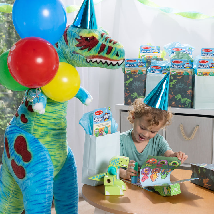 A kid playing with The Melissa & Doug Sticker WOW!™ 24-Page Activity Pad and Sticker Stamper, 300 Stickers, Arts and Crafts Fidget Toy Collectible Character – Dinosaur