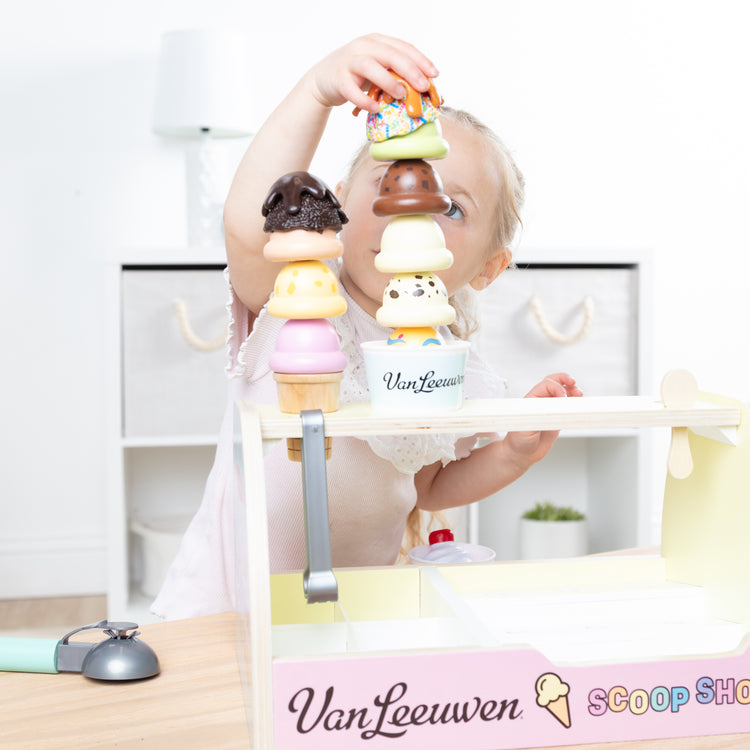 A kid playing with The Van Leeuwen Scoop Shop Ice Cream Play St