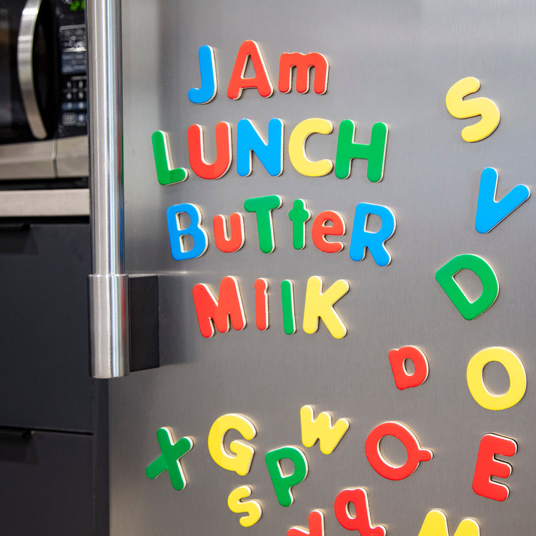 A playroom scene with The Melissa & Doug 52 Wooden Alphabet Magnets in a Box - Uppercase and Lowercase Letters