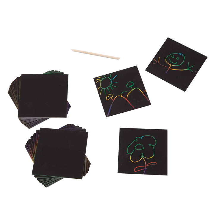 The loose pieces of The Melissa & Doug Scratch Art Rainbow Mini Notes (125) With Wooden Stylus
