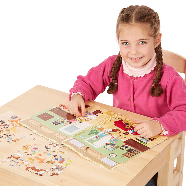 A child on white background with The Melissa & Doug Pet Shop Puffy Sticker Set With 115 Reusable Stickers