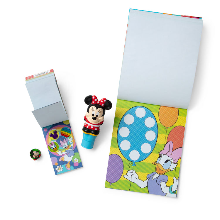 The loose pieces of The Melissa & Doug Sticker WOW!™ Disney Minnie Mouse Bundle: 24-Page Activity Pad, Sticker Stamper, 500 Stickers, Mini Pad, Arts and Crafts Fidget Toy Collectible Character