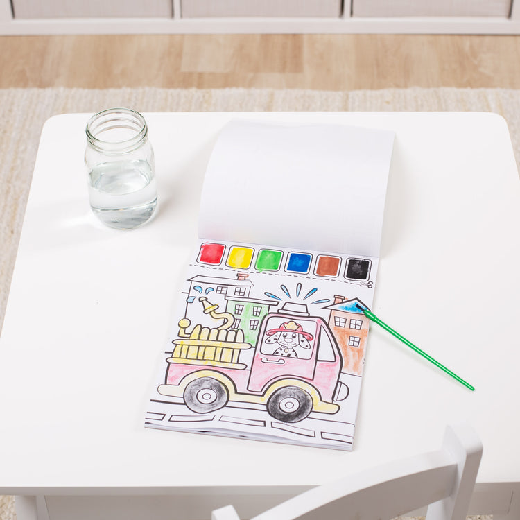 A playroom scene with The Melissa & Doug Paint With Water - Vehicles, 20 Perforated Pages With Spillproof Palettes