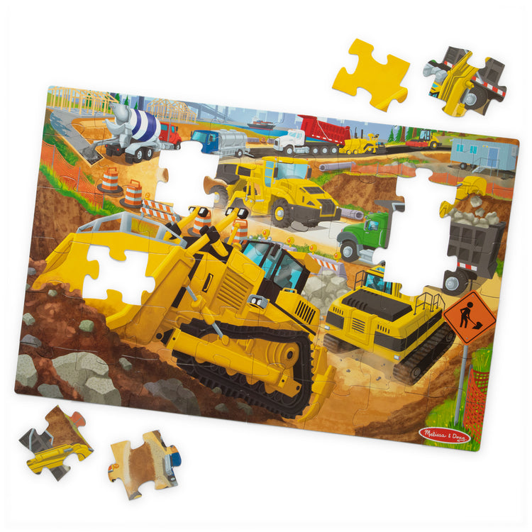 The loose pieces of The Melissa & Doug Building Site, Construction Themed Jumbo Floor Puzzle, 48‑Piece Construction Vehicle Jigsaw Puzzle, 3 x 2 Foot Toddler Puzzles for Kids Ages 3+