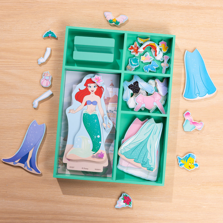 A playroom scene with The Melissa & Doug Disney Princess Ariel Magnetic Dress-Up Wooden Doll Pretend Play Set (30+ Pieces)