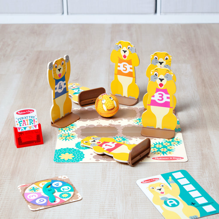 A playroom scene with The Melissa & Doug Fun at the Fair! Wooden Armadillo Roll & Bowl Prairie Dog Bowling Game