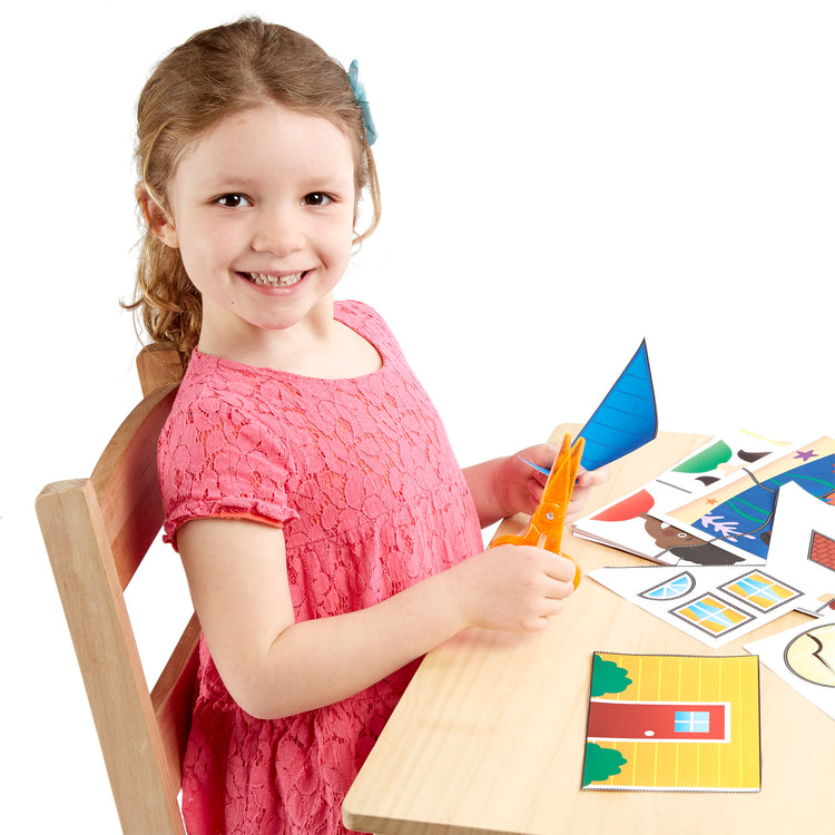 A child on white background with The Melissa & Doug Scissor Skills and Tape Activity Books Set