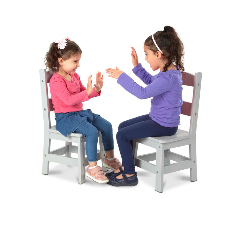 A child on white background with The Melissa & Doug Kids Furniture Wooden Chair Pair - Gray