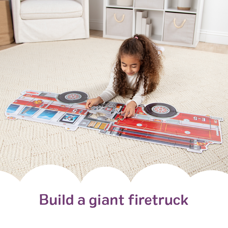A kid playing with The Melissa & Doug Giant Fire Truck Shaped Jumbo Floor Puzzle, 24-Piece Fire Engine Jigsaw Puzzle, Over 4 Ft Long Kids Puzzles for Toddlers Ages 3+
