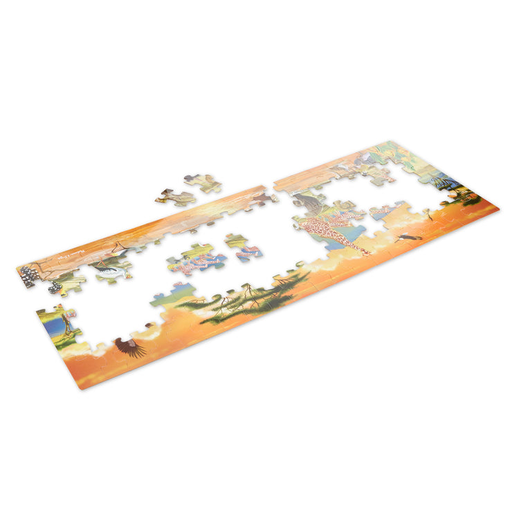 The loose pieces of The Melissa & Doug African Plains Safari Jumbo Jigsaw Floor Puzzle (100 pcs, over 4 feet long)