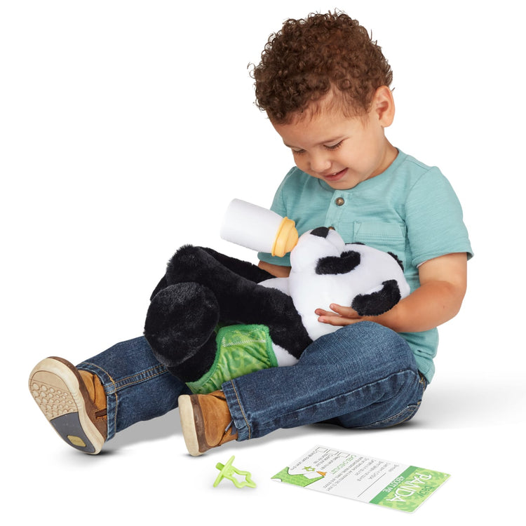 A child on white background with the Melissa & Doug 11-Inch Baby Panda Plush Stuffed Animal with Pacifier, Diaper, Baby Bottle