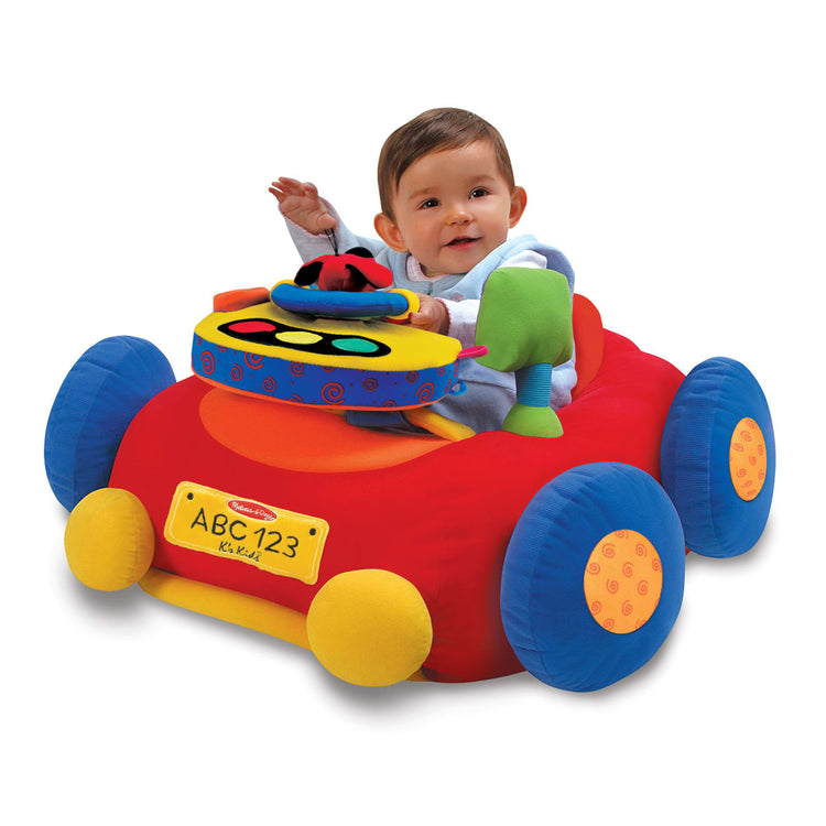 A child on white background with the Melissa & Doug Beep-Beep and Play Activity Center Baby Toy