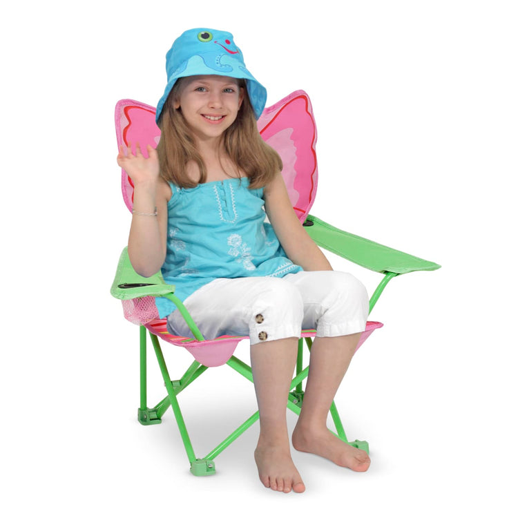 A child on white background with the Melissa & Doug Sunny Patch Bella Butterfly Outdoor Folding Lawn and Camping Chair