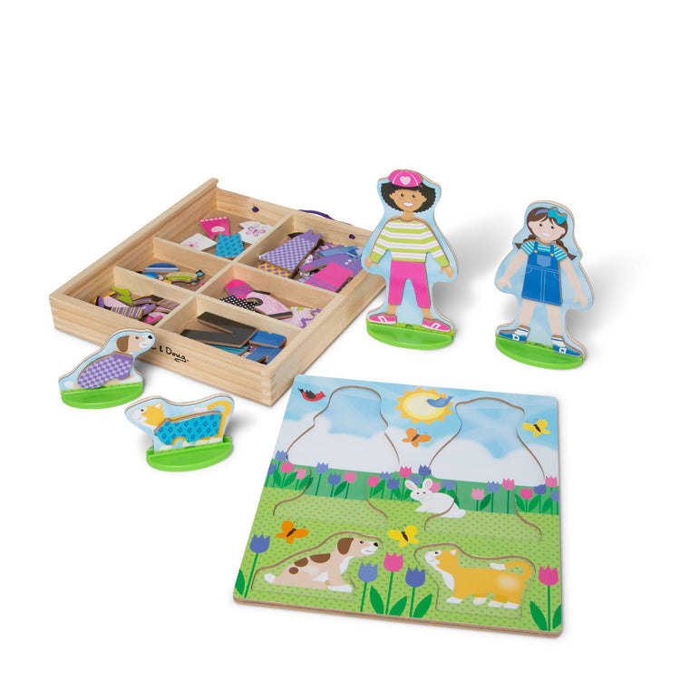 The loose pieces of the Melissa & Doug Best Friends Magnetic Dress-Up Wooden Dolls Pretend Play Set (78 pcs)