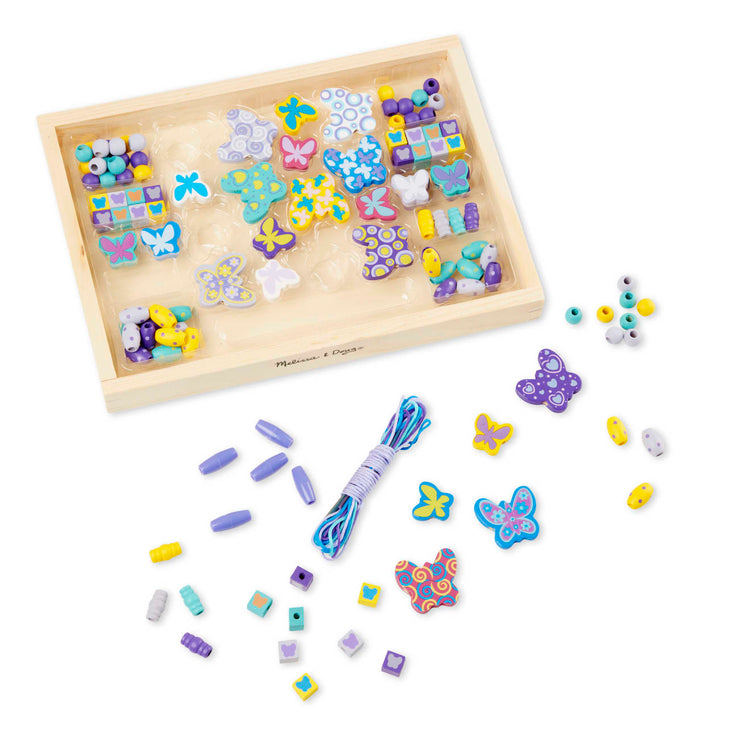 The loose pieces of the Melissa & Doug Created by Me! Butterfly Beads Wooden Bead Kit, 150+ Beads for Jewelry-Making