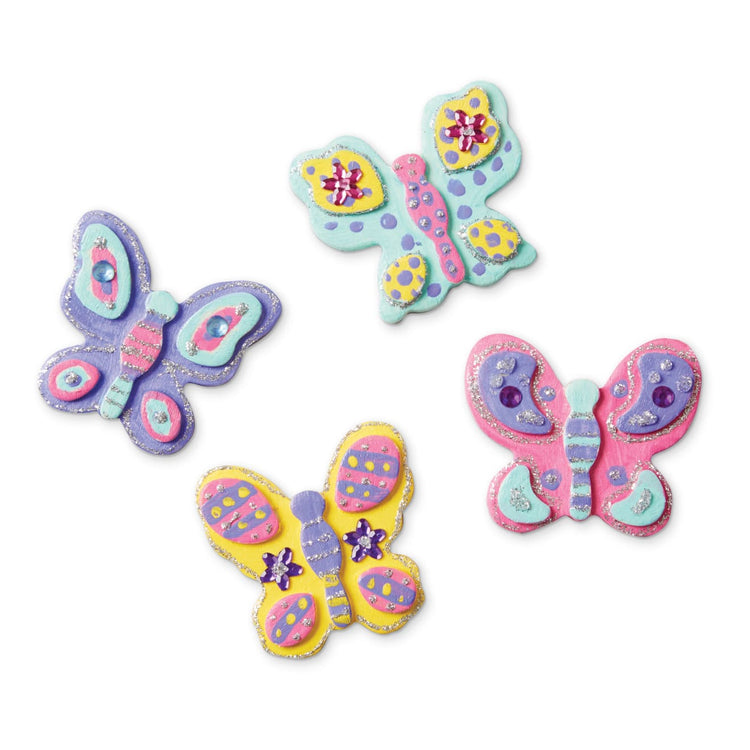 An assembled or decorated the Melissa & Doug Created by Me! Wooden Butterfly Magnets Craft Kit (4 Designs, 4 Paints, Stickers, Glitter Glue)