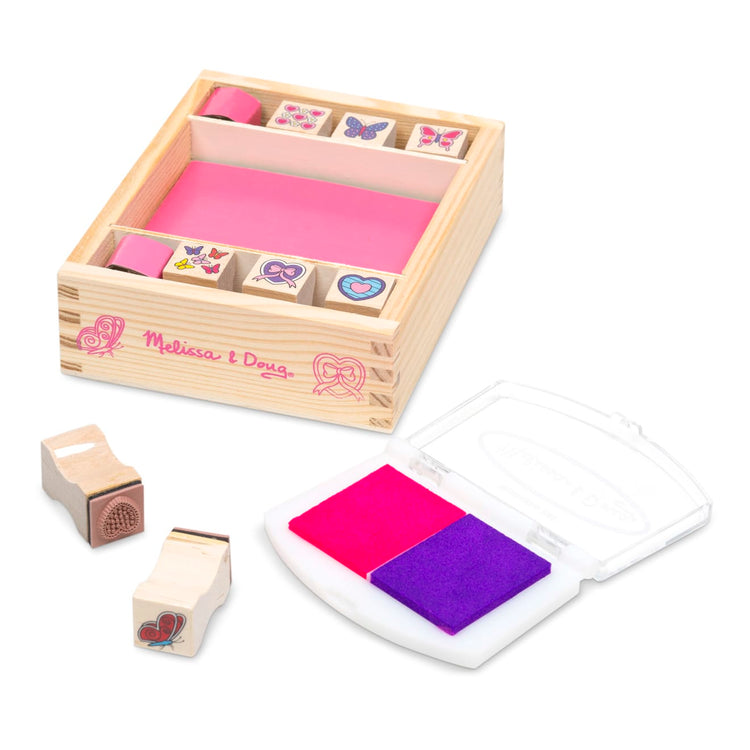 The loose pieces of the Melissa & Doug Butterfly and Heart Wooden Stamp Set: 8 Stamps and 2-Color Stamp Pad