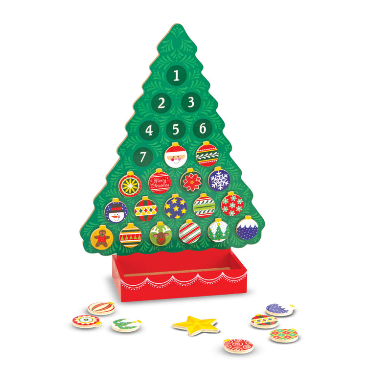 The loose pieces of the Melissa & Doug Countdown to Christmas Wooden Advent Calendar - Magnetic Tree, 25 Magnets