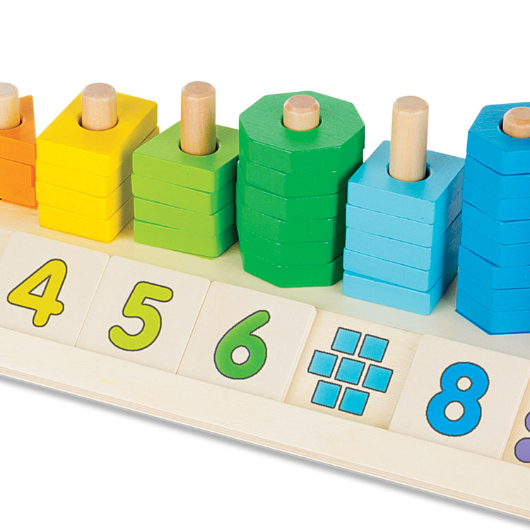 The loose pieces of the Melissa & Doug Counting Shape Stacker - Wooden Educational Toy With 55 Shapes and 10 Number Tiles