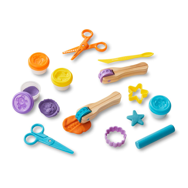 The loose pieces of the Melissa & Doug Created by Me! Cut, Sculpt, and Roll Modeling Dough Kit With 8 Tools and 4 Colors of Modeling Dough