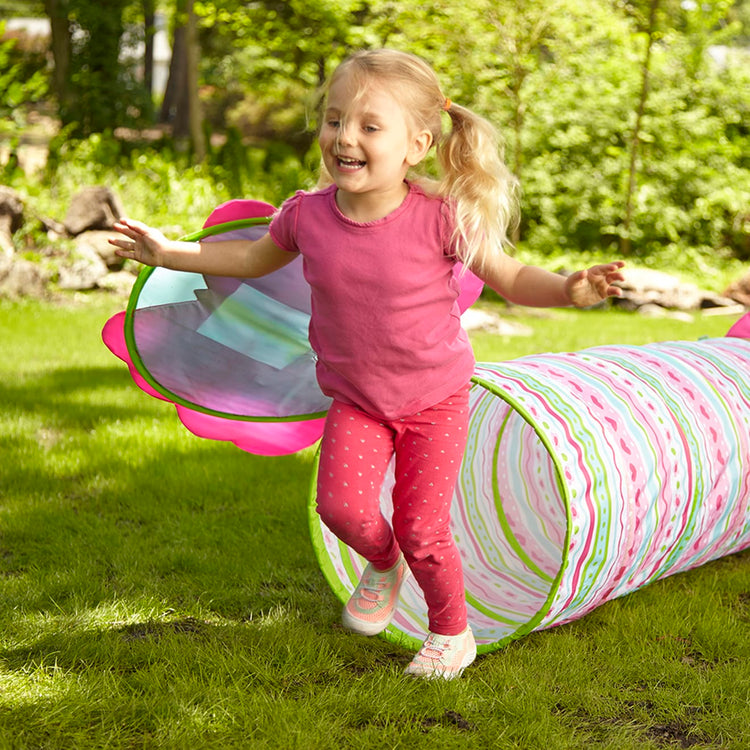 A kid playing with the Melissa & Doug Sunny Patch Cutie Pie Butterfly Crawl-Through Tunnel (almost 5 feet long)