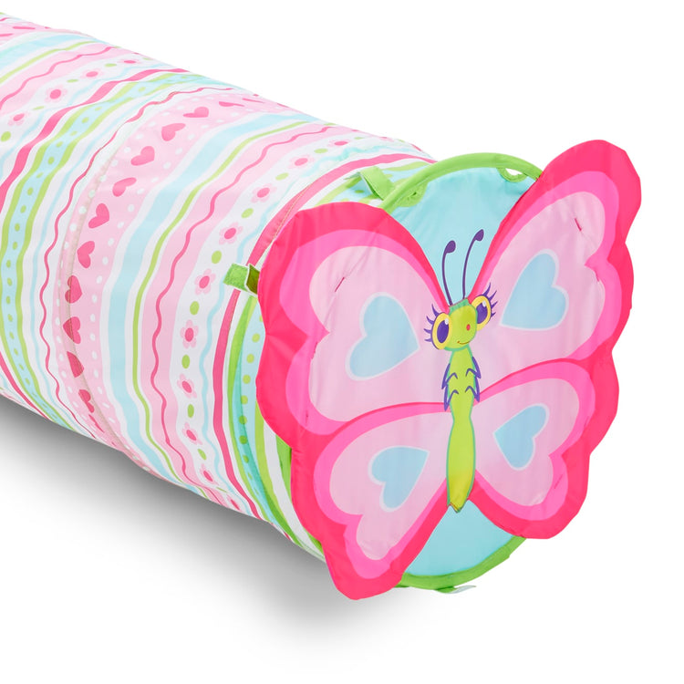 A child on white background with the Melissa & Doug Sunny Patch Cutie Pie Butterfly Crawl-Through Tunnel (almost 5 feet long)