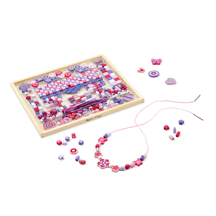 The loose pieces of the Melissa & Doug Sparkle & Shimmer Wooden Bead Set: 340 Beads and 12 Laces for Jewelry-Making
