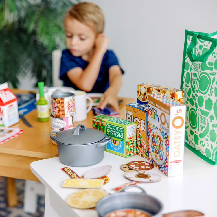 https://www.melissaanddoug.com/cdn/shop/products/Deluxe-Kitchen-Collection-Cooking-Play-Food-Set-031660-1-Kid-Lifestyle_27482c32-bb0c-4bb0-a657-e431a21ce6ff.jpg?v=1664894417&width=750