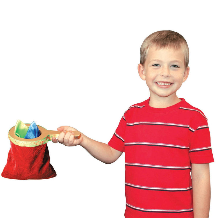 A child on white background with the Melissa & Doug Deluxe Solid-Wood Magic Set With 10 Classic Tricks