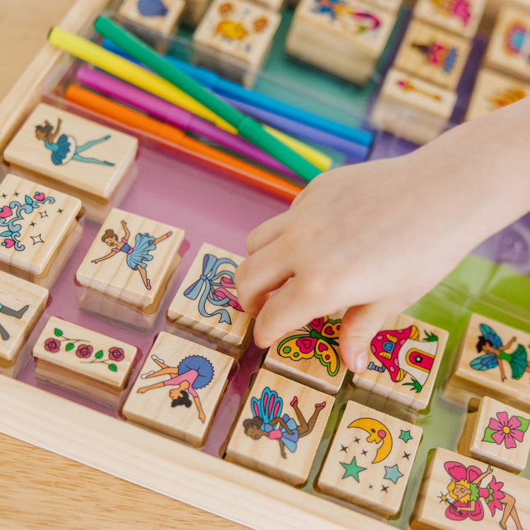 The front of the box for the Melissa & Doug Deluxe Wooden Stamp and Coloring Set – Fairy Tale (30 Stamps, 6 Markers, 2 Durable 2-Color Stamp Pads)
