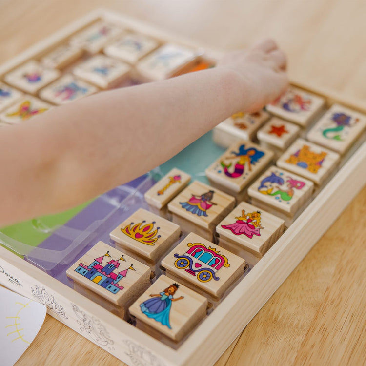 The front of the box for the Melissa & Doug Deluxe Wooden Stamp and Coloring Set – Fairy Tale (30 Stamps, 6 Markers, 2 Durable 2-Color Stamp Pads)