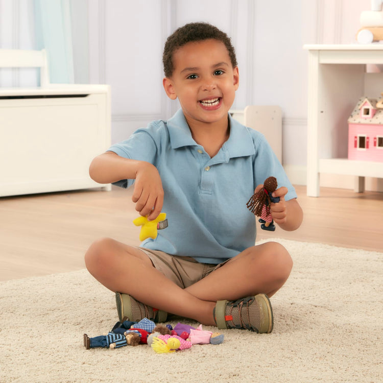 A kid playing with the Melissa & Doug 7-Piece Poseable Wooden Doll Family for Dollhouse (2-4 inches each)