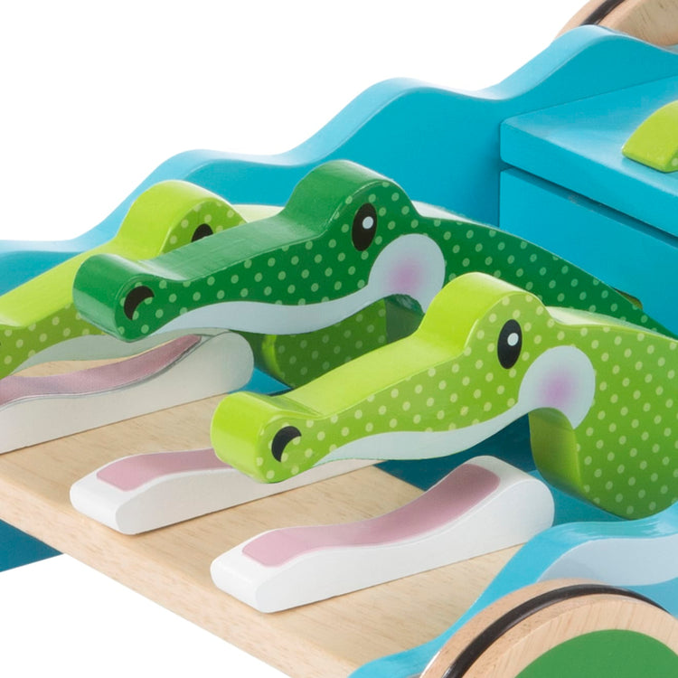 The loose pieces of the Melissa & Doug First Play Chomp and Clack Alligator Wooden Push Toy and Activity Walker