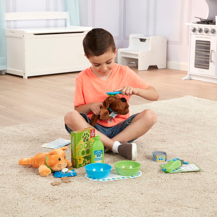 A kid playing with the Melissa & Doug Feeding and Grooming Pet Care Play Set