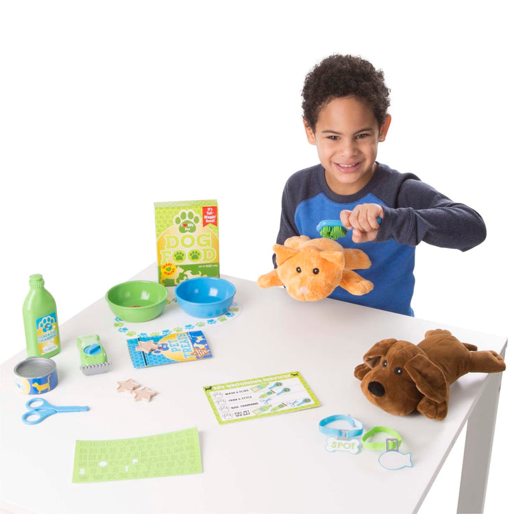 A child on white background with the Melissa & Doug Feeding and Grooming Pet Care Play Set