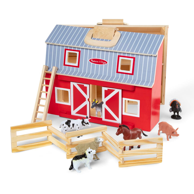 The loose pieces of the Melissa & Doug Fold and Go Wooden Barn With 7 Animal Play Figures