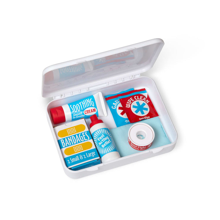 The loose pieces of the Melissa & Doug Get Well First Aid Kit Play Set – 25 Toy Pieces