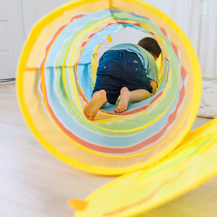 A kid playing with the Melissa & Doug Sunny Patch Giddy Buggy Crawl-Through Tunnel (almost 5 feet long)
