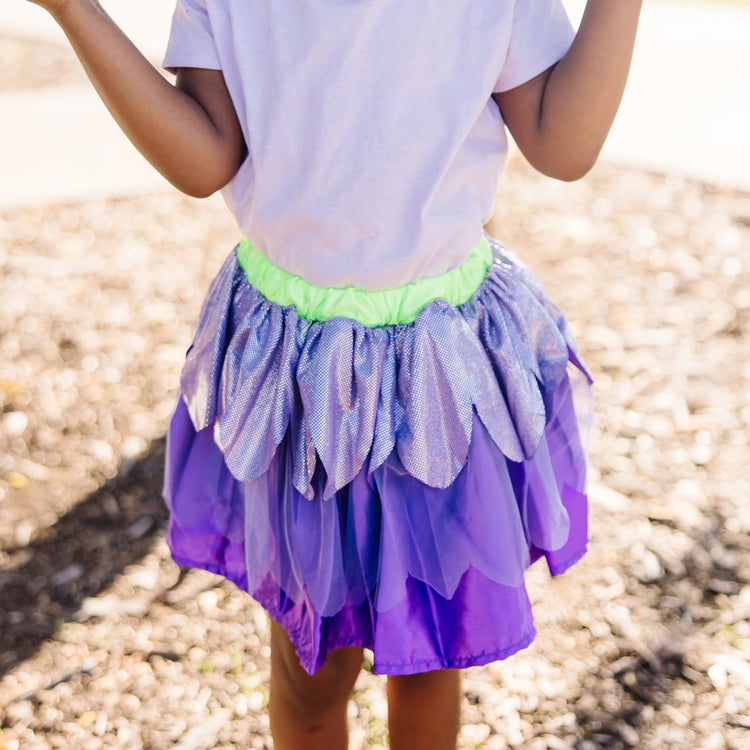 A kid playing with the Melissa & Doug Role Play Collection - Goodie Tutus! Dress-Up Skirts Set (4 Costume Skirts)