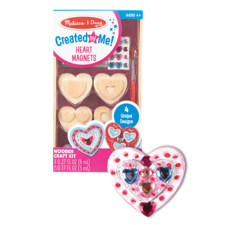 The loose pieces of the Melissa & Doug Created by Me! Wooden Heart Magnets Craft Kit (4 Designs, 4 Paints, Stickers, Glitter Glue)