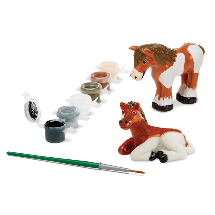 The loose pieces of the Melissa & Doug Created by Me! Horse Figurines Craft Kit (2 Resin Horses, 6 Paints, Paintbrush)