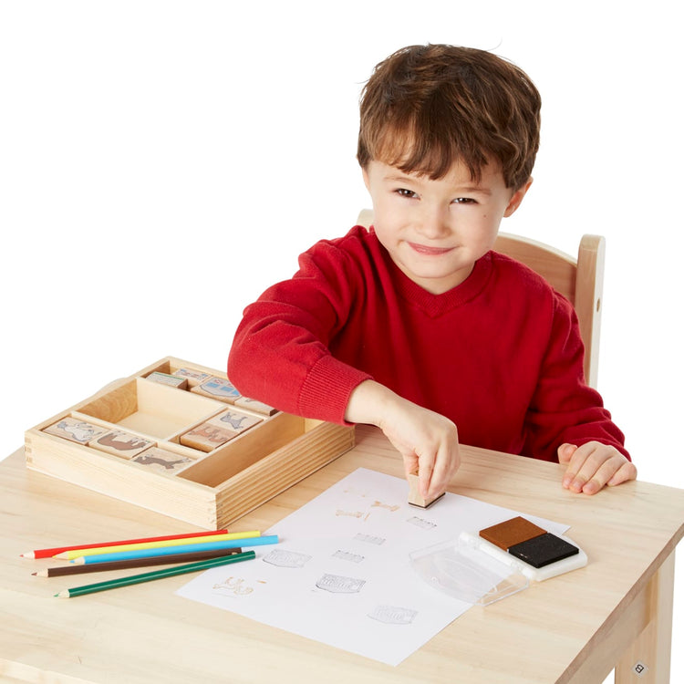 A child on white background with the Melissa & Doug Wooden Stamp Activity Set: Horses - 10 Stamps, 5 Colored Pencils, 2-Color Stamp Pad