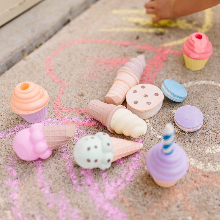 A kid playing with the Melissa & Doug Sweet Treats Chalk Play Set (12 Pieces)