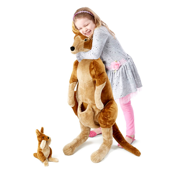 A child on white background with the Melissa & Doug Giant Kangaroo and Baby Joey in Pouch - Lifelike Stuffed Animal (nearly 3 feet tall)