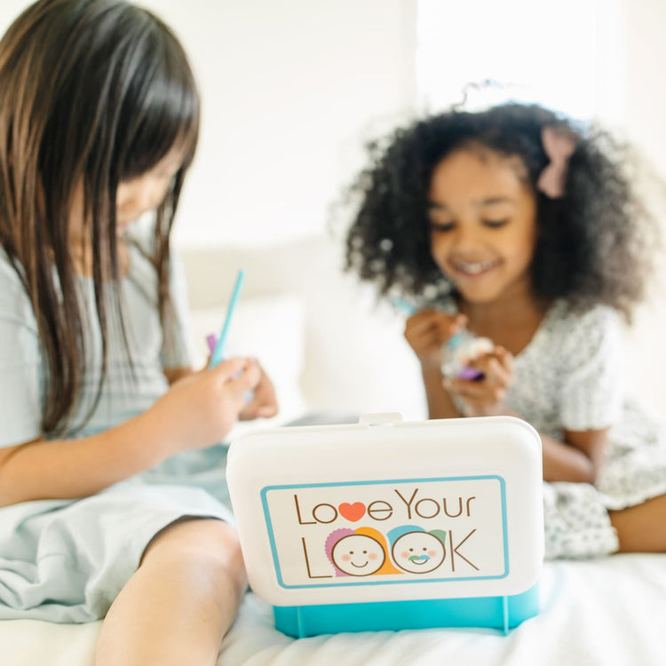 A kid playing with the Melissa & Doug Love Your Look Pretend Makeup Kit Play Set – 16 Pieces for Mess-Free Pretend Makeup Play (DOES NOT CONTAIN REAL COSMETICS)