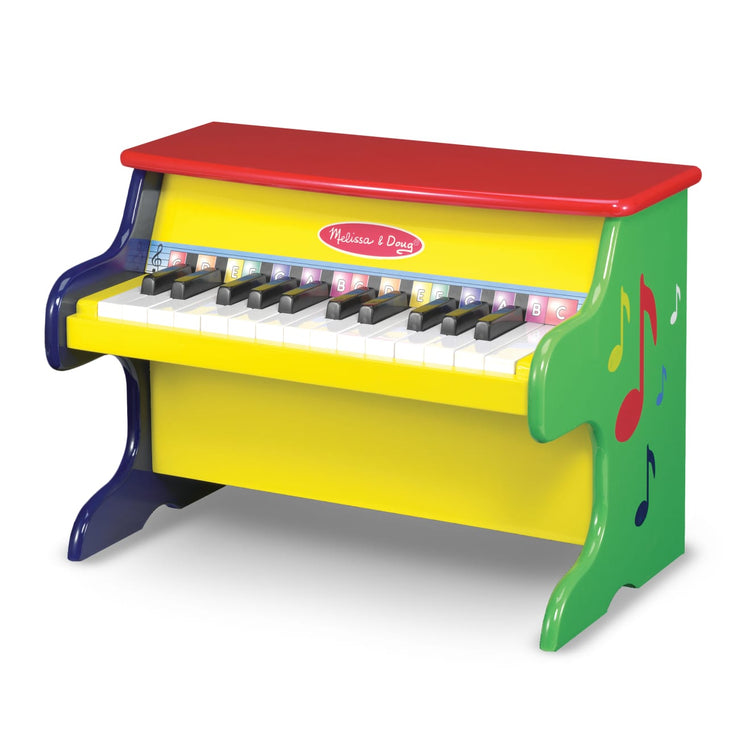 The loose pieces of the Melissa & Doug Learn-To-Play Toy Piano With 25 Keys and Color-Coded Songbook